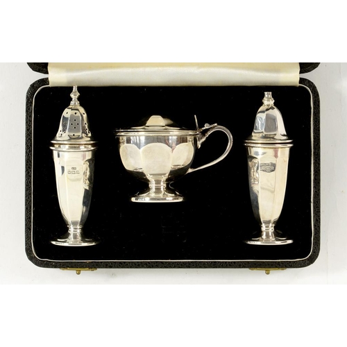 110 - AN ELIZABETH II SILVER THREE PIECE CONDIMENT SET OF PANELLED VASULAR DESIGN, BLUE GLASS LINER, CASTE... 