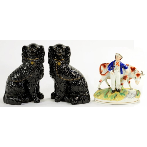 128 - A STAFFORDSHIRE FIGURE AND A CONTEMPORARY PAIR OF STAFFORDSHIRE BLACK GLAZED EARTHENWARE SPANIELS, W... 