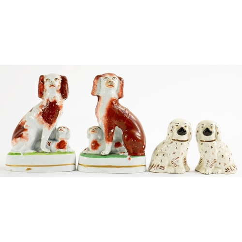 174 - A PAIR OF STAFFORDSHIRE EARTHENWARE SPANIEL GROUPS, DECORATED IN SPONGED RUST ENAMEL, 17.5CM H, C186... 