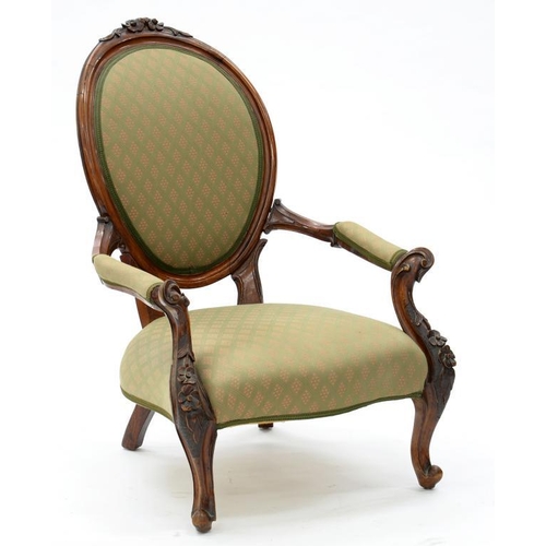 410 - A VICTORIAN CARVED WALNUT OPEN ARM CHAIR, WITH PADDED OVAL BACK