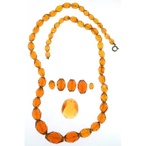 56 - A NECKLACE OF FACETED AMBER GLASS BEADS AND SEVERAL SIMILAR LOOSE BEADS