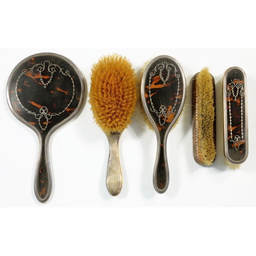 72A - A GEORGE V SILVER FIVE PIECE BRUSH SET, WITH SILVER INLAID TORTOISESHELL INSET BACKS, LONDON 1923... 