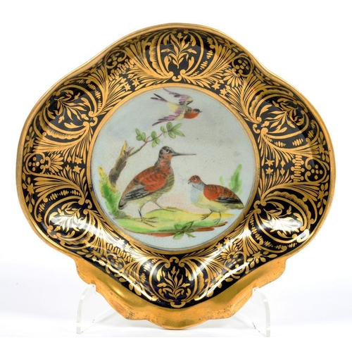 215 - AN ENGLISH PORCELAIN SHELL SHAPED DESSERT DISH, PAINTED WITH THREE BIRDS RESERVED ON A RICHLY GILT V... 