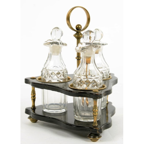 427 - A VICTORIAN BRASS MOUNTED TRIANGULAR PAPIER MACHE CRUET FRAME AND THREE CONTEMPORARY CUT GLASS CONDI... 