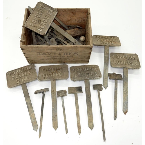 434 - A QUANTITY OF CAST METAL PLANT TALLIES, C1930-50, IN A TAYLOR'S WOOD PORT CRATE 