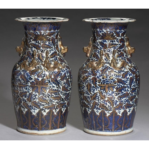 550 - A  PAIR OF 'CLOBBERED' CANTON BLUE AND WHITE VASES, 19TH C with applied gilt chilong and dog of Fo h... 