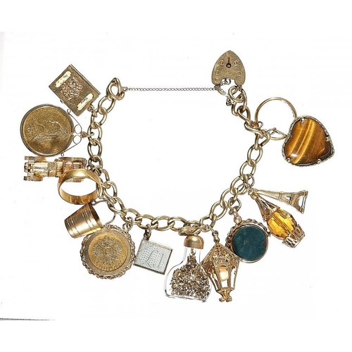 72 - A GOLD CHARM BRACELET  the charms including Sovereign 1889M, Russia 5 Roubles 1898 and two 22ct gold... 