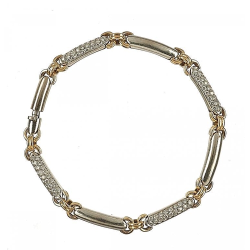 73 - A DIAMOND AND TWO COLOUR GOLD BRACELET with alternately plain and pave set links, 19cm, foreign cont... 