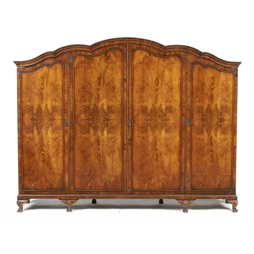 853 -  A WALNUT WARDROBE, EARLY 20TH C  the moulded cavetto cornice with arched centre above four quarter ... 