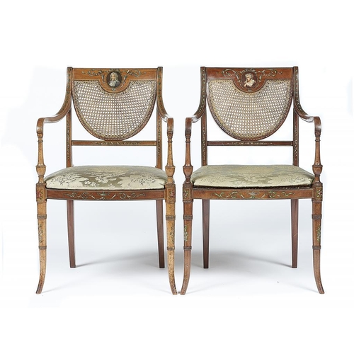 869 - A PAIR OF REGENCY STYLE PAINTED   ELBOW CHAIRS, C1930   with caned U shaped splat and seat, the rail... 