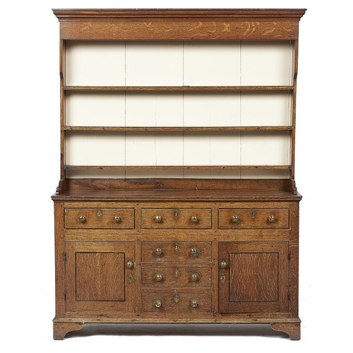 873 - AN OAK DRESSER,  NORTH WALES, FIRST HALF 19TH C  with three shelf boarded rack, the base fitted with... 