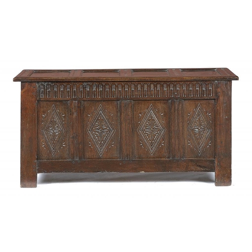 879 - AN OAK CHEST IN CHARLES II STYLE, 19TH/EARLY 20TH C   the  four panel lid and nulled frieze above fo... 