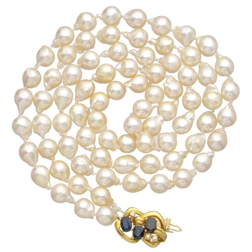 91 - A CULTURED PEARL NECKLACE  with seventy nine approx 8mm baroque pearls and sapphire and diamond set ... 