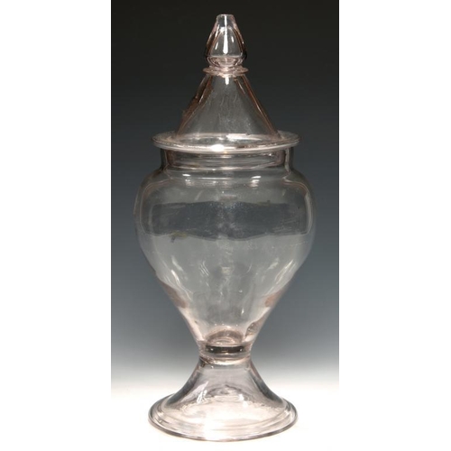 113 - AN ENGLISH GLASS JAR AND COVER, 18TH/EARLY 19TH C of tapered form on folded foot, 34cm h, sharp pont... 