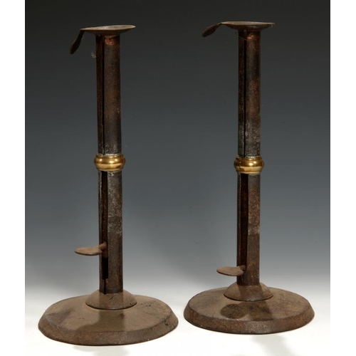 532 - A PAIR OF GEORGE III SHEET IRON AND BRASS MOUNTED 'HOG SCRAPPER' CANDLESTICKS, C1800 with sliding pu... 