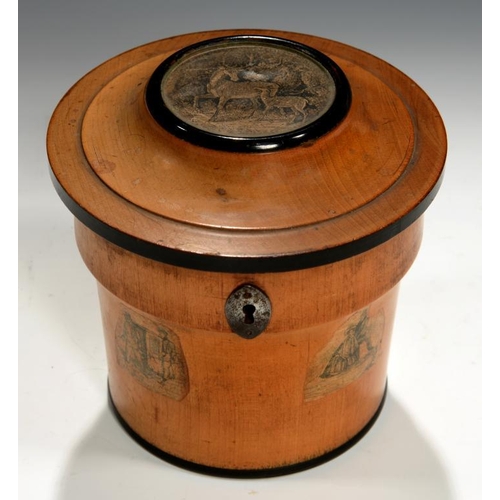 549 - AN UNUSUAL REGENCY CYLINDRICAL FRUITWOOD AND EBONISED TEA CADDY, C1800 inset and applied with cut pa... 