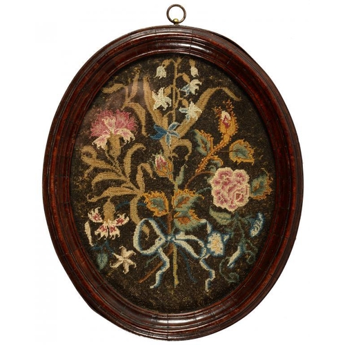 605 - TWO ENGLISH EMBROIDERED PICTURES, C1720  AND C1770  the oval   picture of flowers tied with a blue r... 