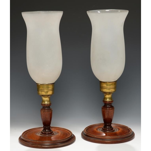 627 - A PAIR OF ENGLISH BRASS AND TURNED MAHOGANY CANDLE LAMPS AND FROSTED GLASS SHADES, SECOND QUARTER 19... 