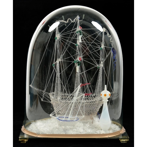 259 - A 19TH C GLASS SHIP FRIGGER WITH SMALLER VESSEL TO FORE AND LIGHTHOUSE, ON PLATE GLASS BASE BENEATH ... 