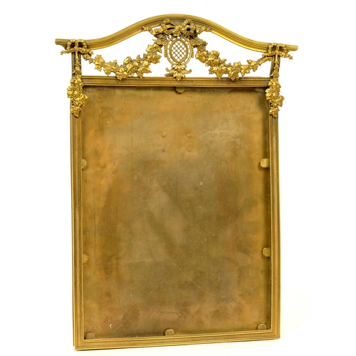 265 - AN EDWARDIAN GILT BRASS PHOTOGRAPH FRAME, HUNG WITH SWAGS AND SURMOUNTED BY A BOW, 36CM H, C1900