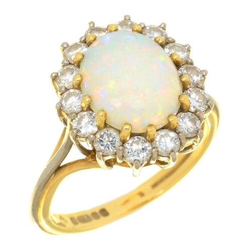 19C - AN OPAL AND DIAMOND CLUSTER RING in 18ct gold, the central opal approx 10 x 8 mm, 6.5g, size N... 