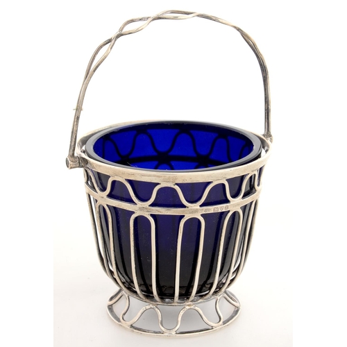 138 - AN EDWARD VII SILVER WIREWORK SUGAR BASKET, BLUE GLASS LINER, 7 CM H, CHESTER 1910, 2OZS 12DWTS