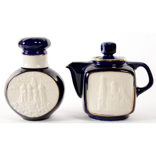 175 -  A RUSSIAN COBALT GROUND PORCELAIN TEAPOT AND COVER AND TEA CADDY AND COVER, EACH WITH M0ULDED ... 