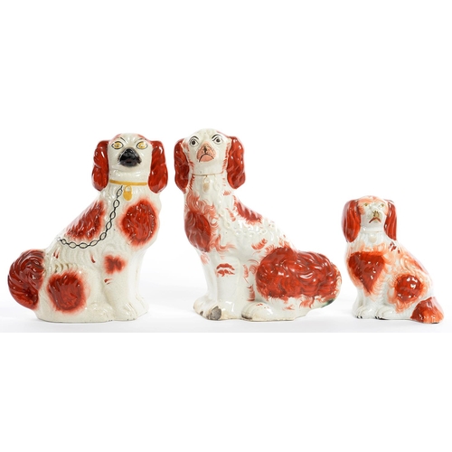 183 - THREE STAFFORDSHIRE EARTHENWARE MODELS OF SPANIELS, WITH SPONGED RUST FEATHERY MARKS, 28CM H, 19TH C