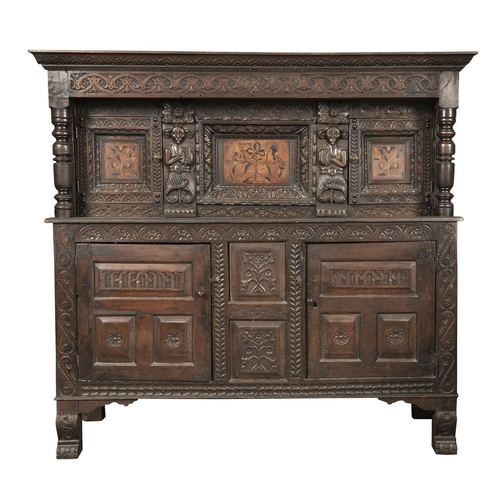 563 - AN ANTIQUARIAN TASTE CARVED OAK LIVERY CUPBOARD, 17TH C AND LATER, THE CENTRE PANEL AND THOSE TO THE... 