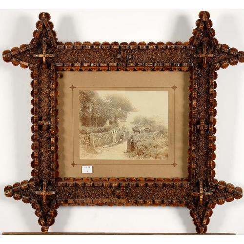 522 - A PAIR OF MONOCHROME VICTORIAN PHOTOGRAPHS IN THE MOST UNUSUAL CORK FRAMES, 55 X 50CM INCLUDING FRAM... 