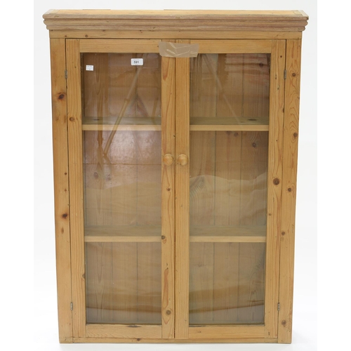 591 - A WAXED PINE BOOKCASE, ENCLOSED BY GLAZED DOORS, EARLY 20TH C, 113CM H; 84 X 18CM