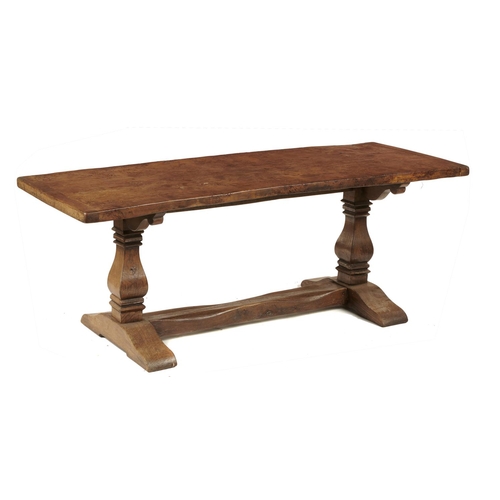 655A - AN OAK TABLE  the single plank burr oak top with cleated ends on two squared baluster end suppo... 