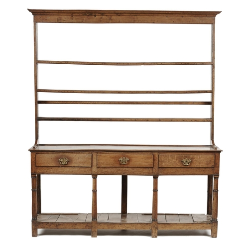 655B - A GEORGE III OAK DRESSER, EARLY 19TH C the lofty rack with cavetto cornice and three moulded sh... 