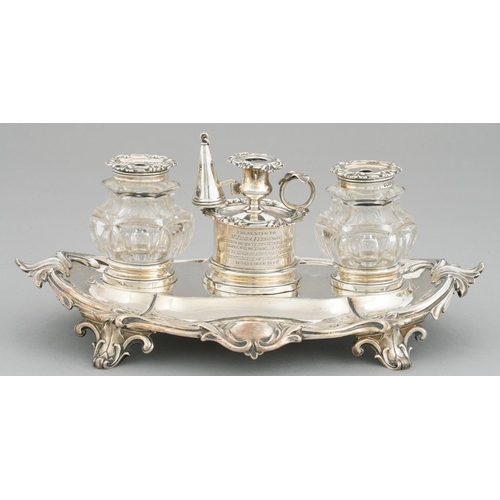 104 - A VICTORIAN SILVER INKSTAND  of leafy scrolling oblong design, with silver taperstick and silver cap... 