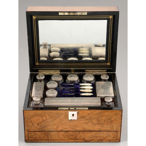 105 - A VICTORIAN SILVER FITTED WALNUT DRESSING CASE  the cut glass accessories with silver cap or cover, ... 