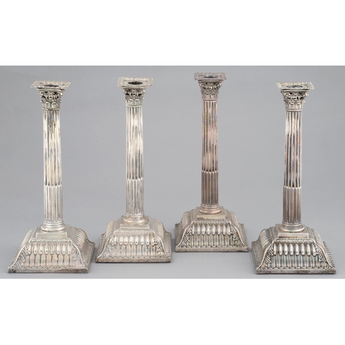 111 - A SET OF FOUR GEORGE III SILVER  CANDLESTICKS   the slightly tapered, stop fluted column beneath pie... 