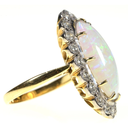 2 - AN OPAL AND DIAMOND RING  the 10 x 19mm oval opal of fine polish, in gold marked 18ct, 7.8g, size M... 
