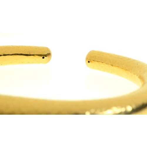 34 - ILIAS LALAOUNIS. A GREEK GOLD BANGLE with two invisible hinges, 74mm, maker's and control mark, 750 ... 