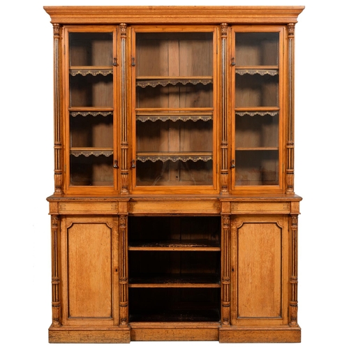 618 - A VICTORIAN LIGHT OAK AND EBONISED BOOKCASE, C1870  with leaf carved and fluted pilasters, the upper... 