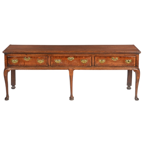 630 - A GEORGE III OAK DRESSER, LATE 18TH C the boarded top with cleated ends, fitted three moulded, cross... 