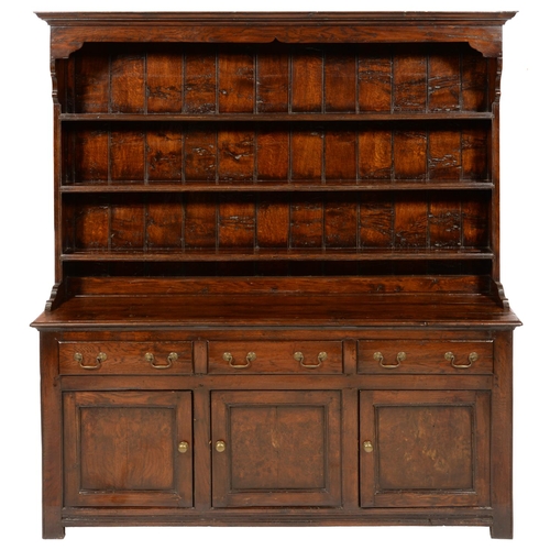 642 - A GEORGE III OAK DRESSER, EARLY 19TH C  with boarded rack, the base fitted with drawers and three pa... 