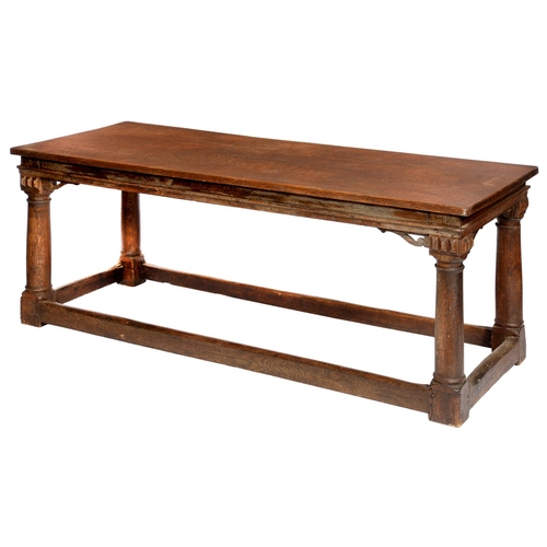 645 - A JAMES I STYLE OAK REFECTORY TABLE  the single plank top on four architectural columnar legs united... 