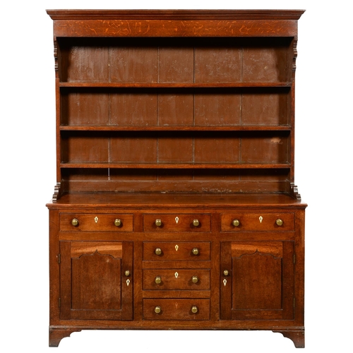 654 - AN OAK DRESSER NORTH WALES,  EARLY 19TH C with moulded cornice to the boarded rack, profile corbels ... 