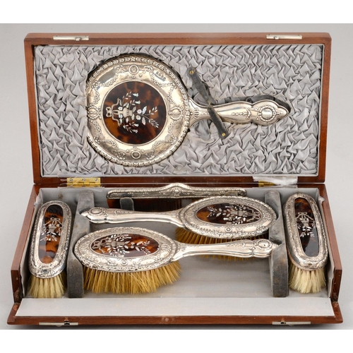 88 - A GEORGE V INLAID TORTOISESHELL INSET SILVER BRUSH SET  embossed with festoons and inlaid in si... 