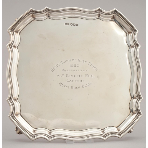 196 - GOLFING INTEREST. A GEORGE V SHAPED SQUARE SILVER SALVER WITH MOULDED BORDER, ON FOUR FEET, ENGRAVED... 