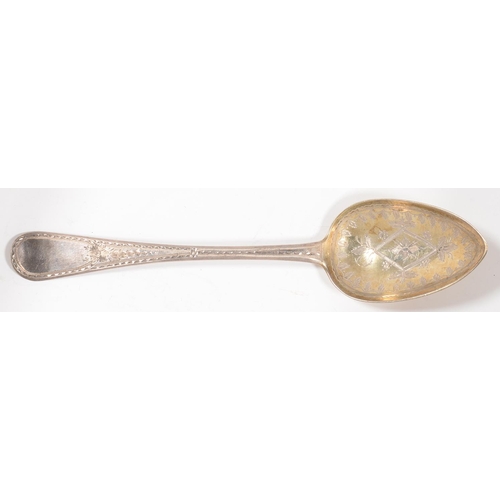 186 - A GEORGE IV SILVER TABLE SPOON, LATER GILT AND ENGRAVED AS A SERVING SPOON, MAKER'S MARK OVERSTRUCK ... 
