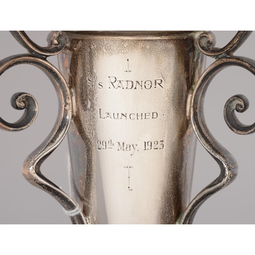 188 - MARITIME INTEREST. A GEORGE V SILVER THREE HANDLED VASE OF TRUMPET SHAPE, ENGRAVED S/S RADNOR LAUNCH... 