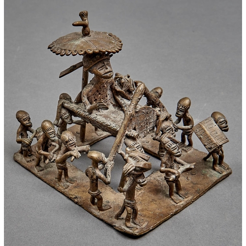 1034 - Tribal art. An Ashanti bronze group, Ghana, first half 20th c, of a king born on a litter beneath an... 