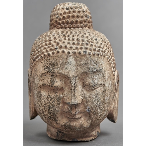 1055 - A South East Asian stone head of Buddha, 25cm h