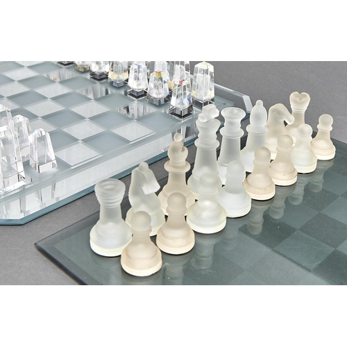 1075 - A Regency Fine Arts lead crystal chess set,  with frosted and clear glass board, the pieces frosted ... 